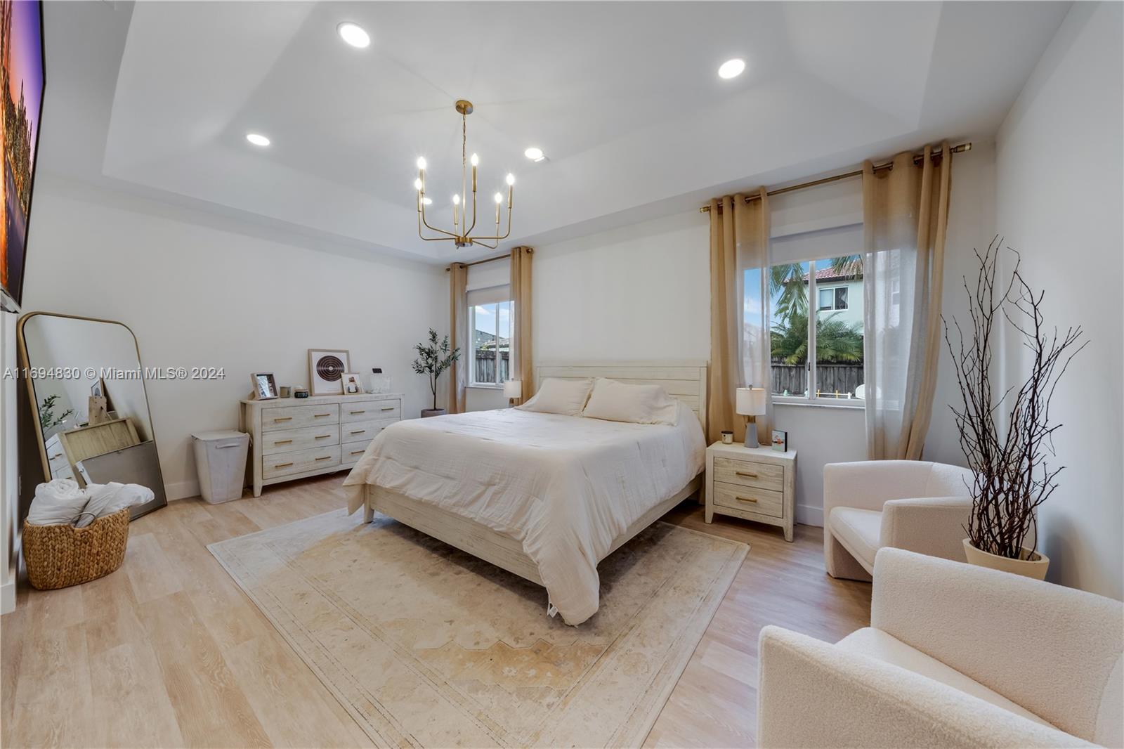 16429 Southwest 54th Terrace Miami, FL 33185 - Photo 14 of 28 a spacious bedroom with a bed a couch and dresser