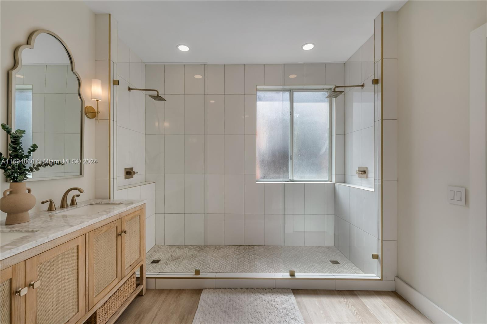 16429 Southwest 54th Terrace Miami, FL 33185 - Photo 18 of 28 a bathroom with a shower sink and mirror