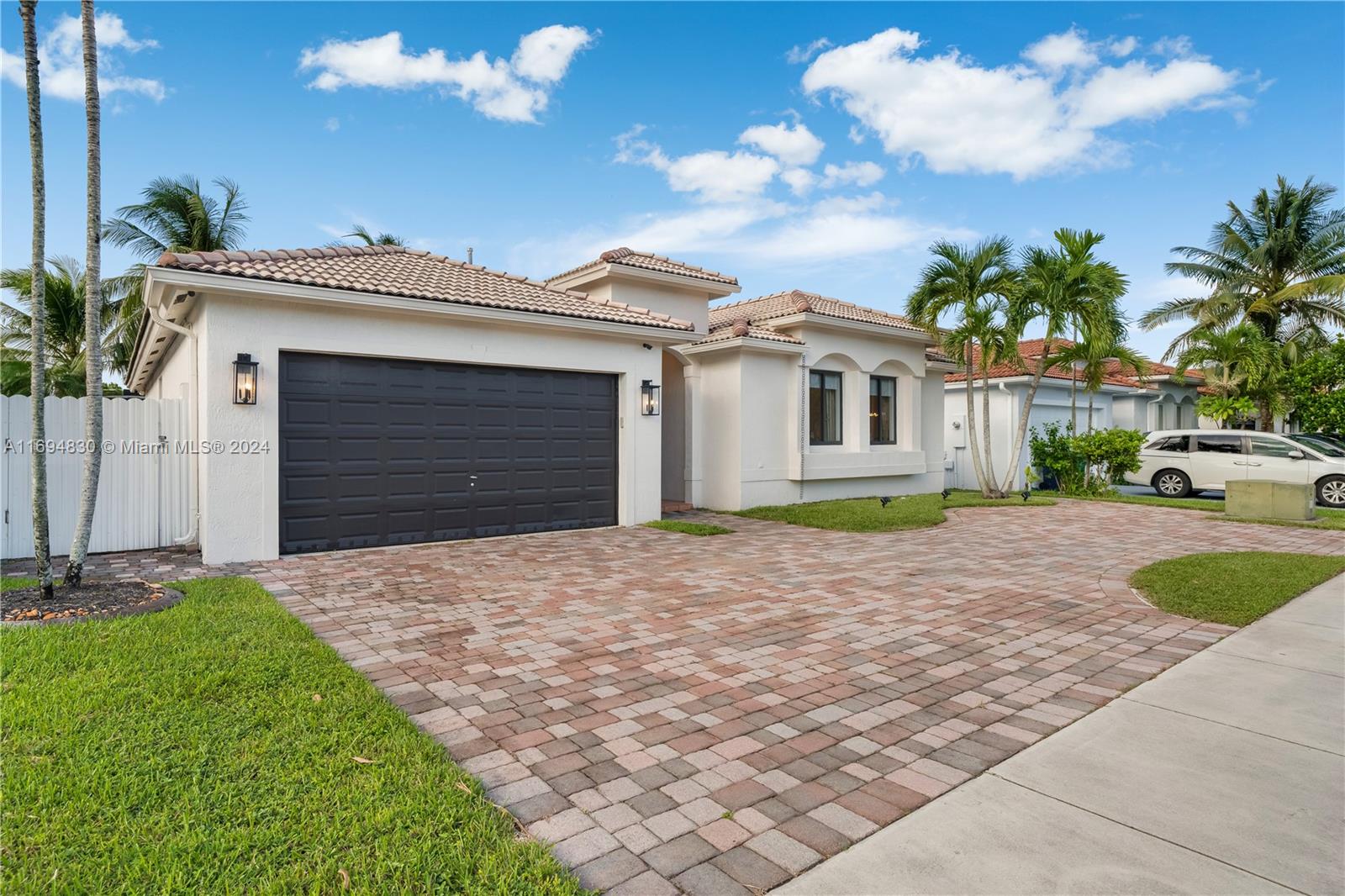 16429 Southwest 54th Terrace Miami, FL 33185 - Photo 4 of 28 a front view of a house with a yard and garage