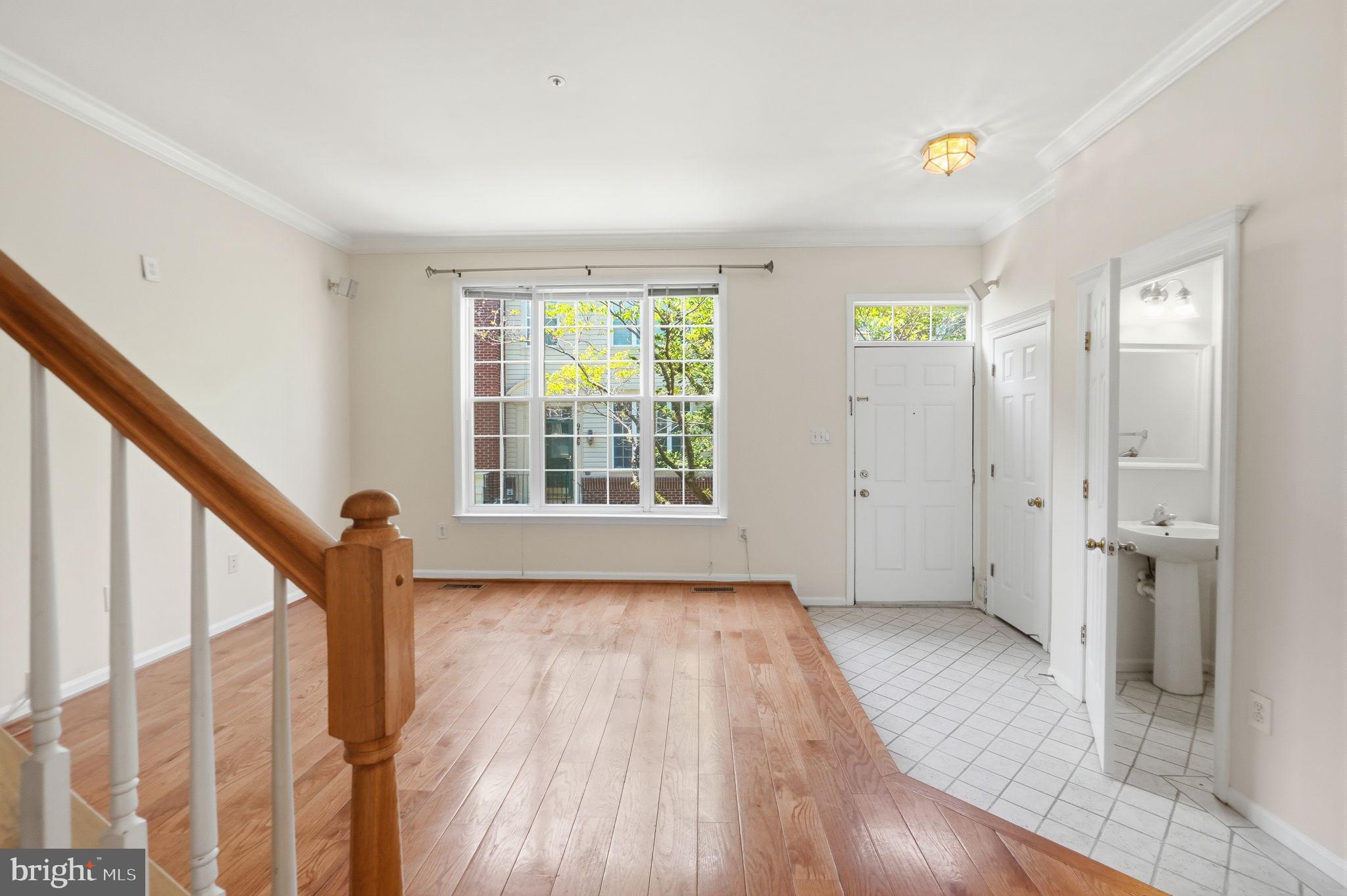 9702 Athletic Way Gaithersburg, MD 20878 - Photo 13 of 29 a view of an empty room with wooden floor and stairs