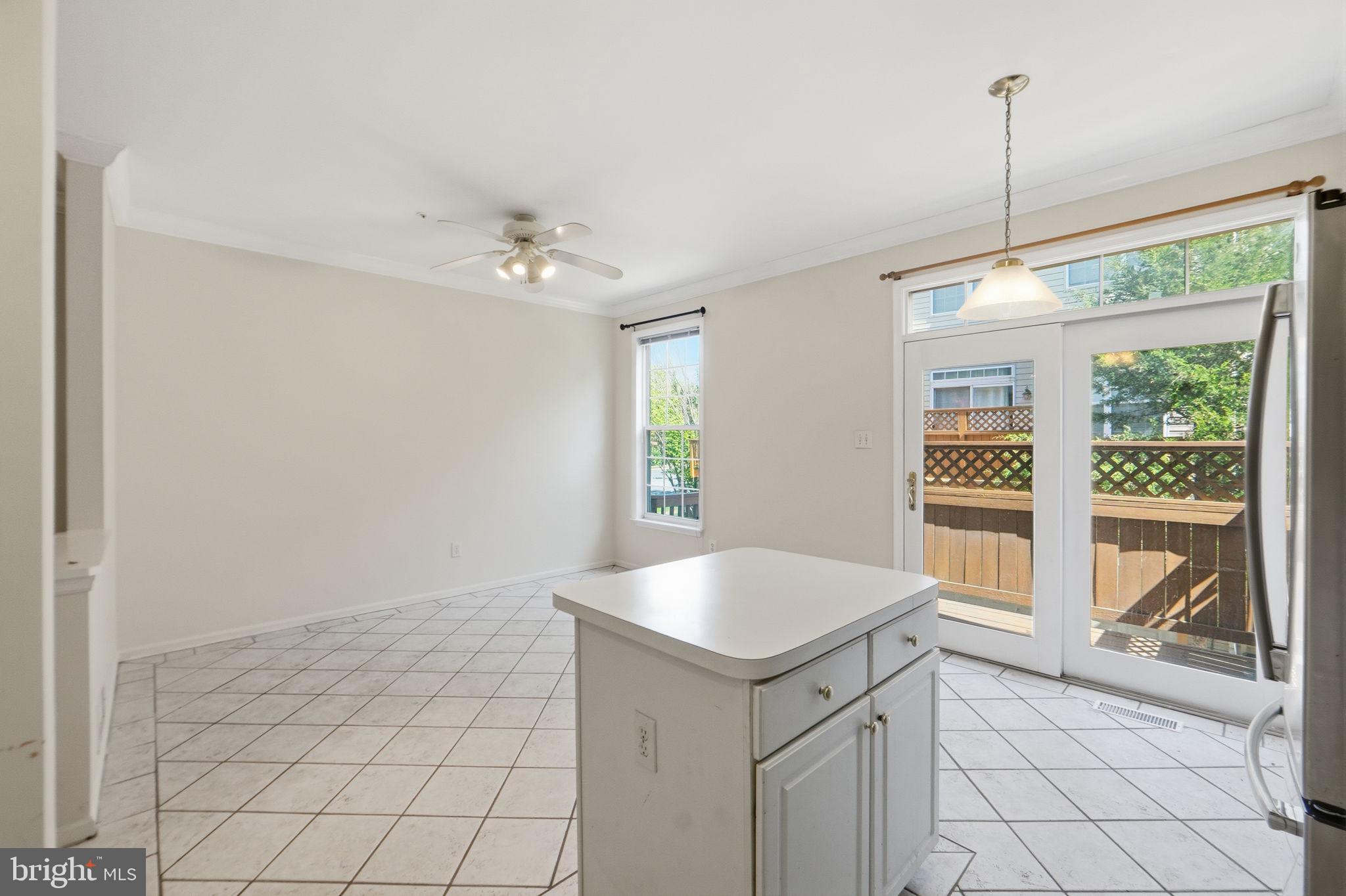 9702 Athletic Way Gaithersburg, MD 20878 - Photo 18 of 29 a kitchen with a sink a chandelier and fireplace