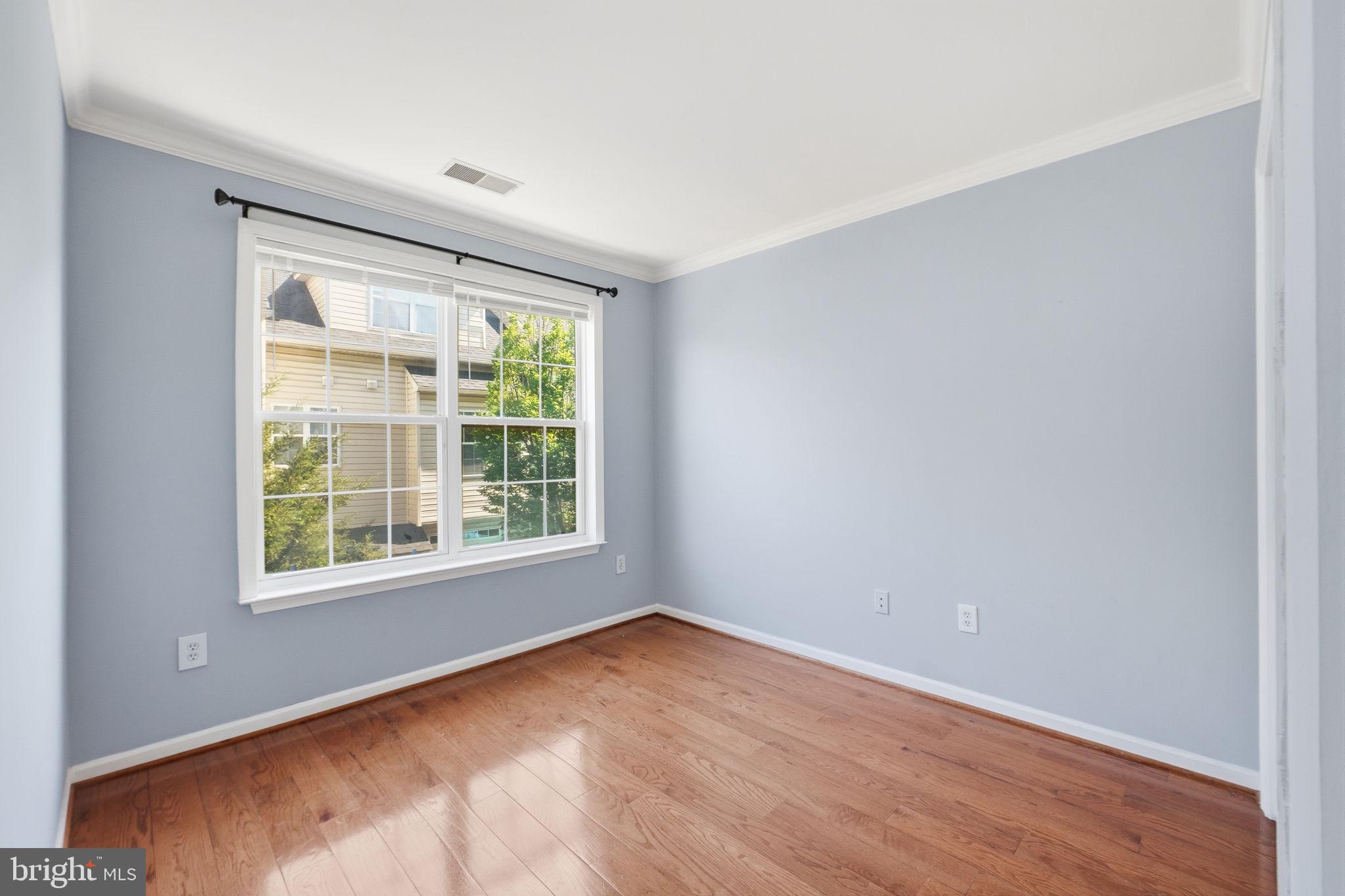 9702 Athletic Way Gaithersburg, MD 20878 - Photo 26 of 29 an empty room with wooden floor and windows