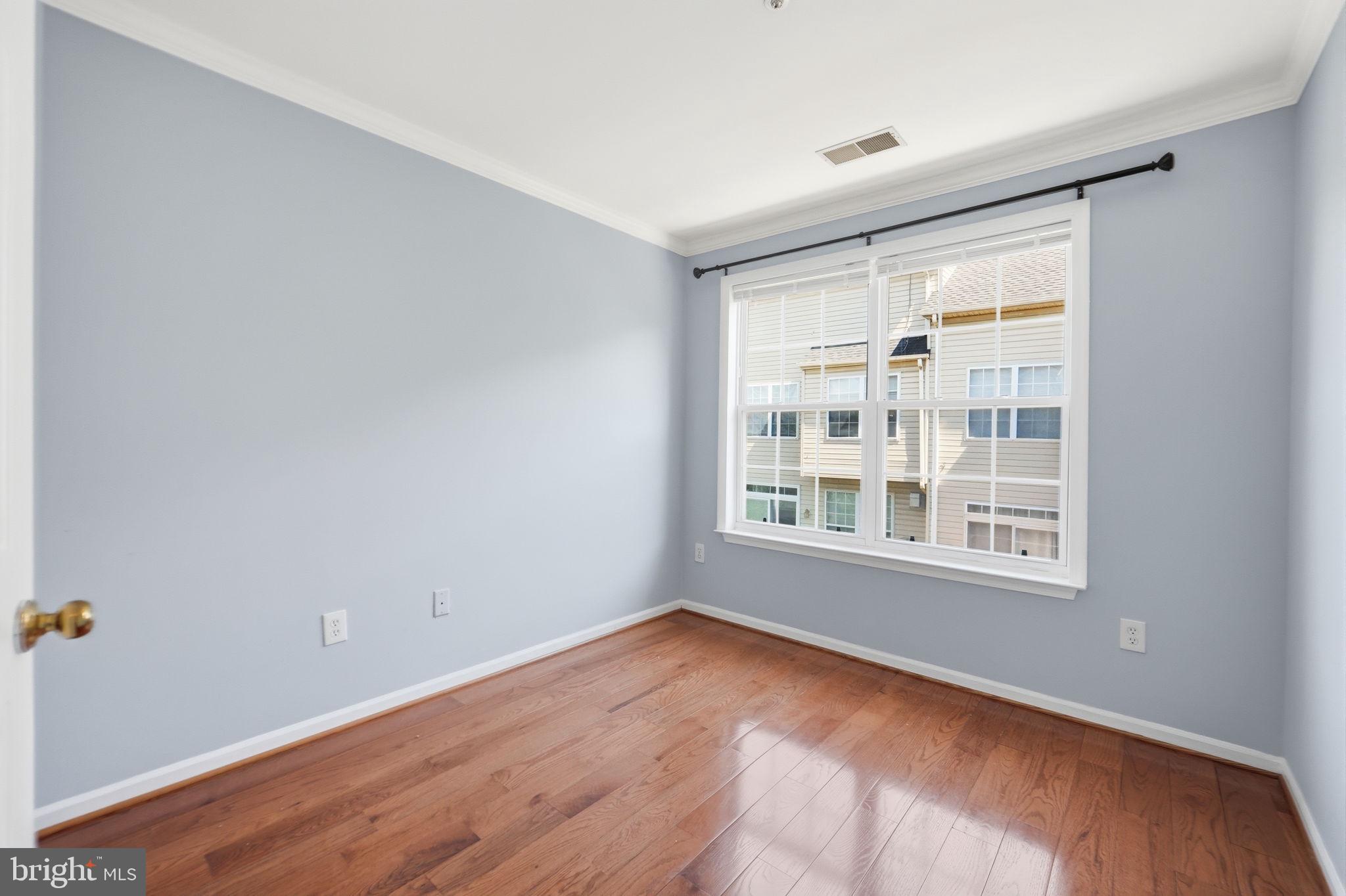 9702 Athletic Way Gaithersburg, MD 20878 - Photo 27 of 29 a view of an empty room with wooden floor and a window
