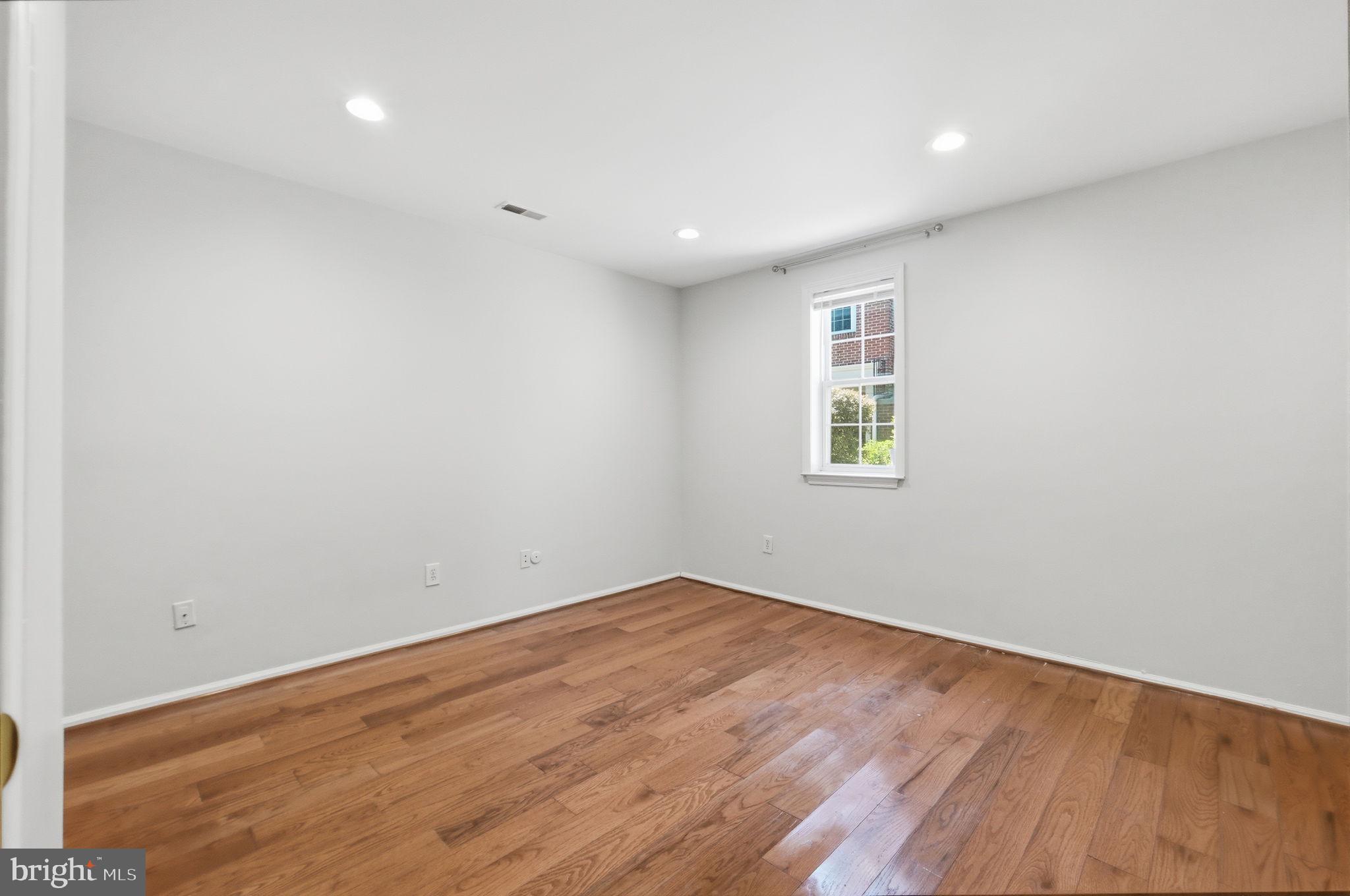 9702 Athletic Way Gaithersburg, MD 20878 - Photo 10 of 29 an empty room with wooden floor and windows