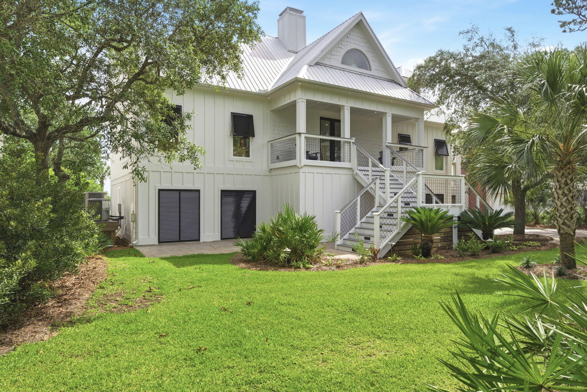 31061 Peninsula Drive Orange Beach, AL 36561 - Photo 2 of 93 a front view of a house with a yard and tree