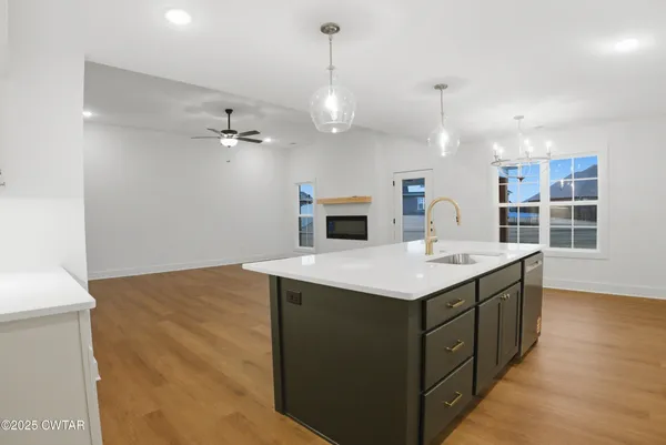 a kitchen with kitchen island a sink stove and oven