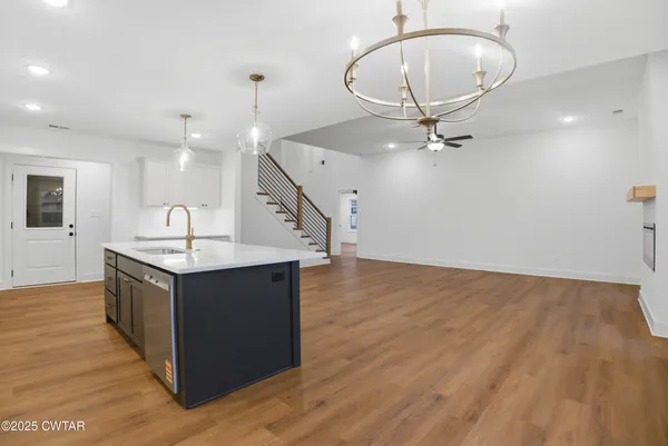 a view of a room with wooden floor and window