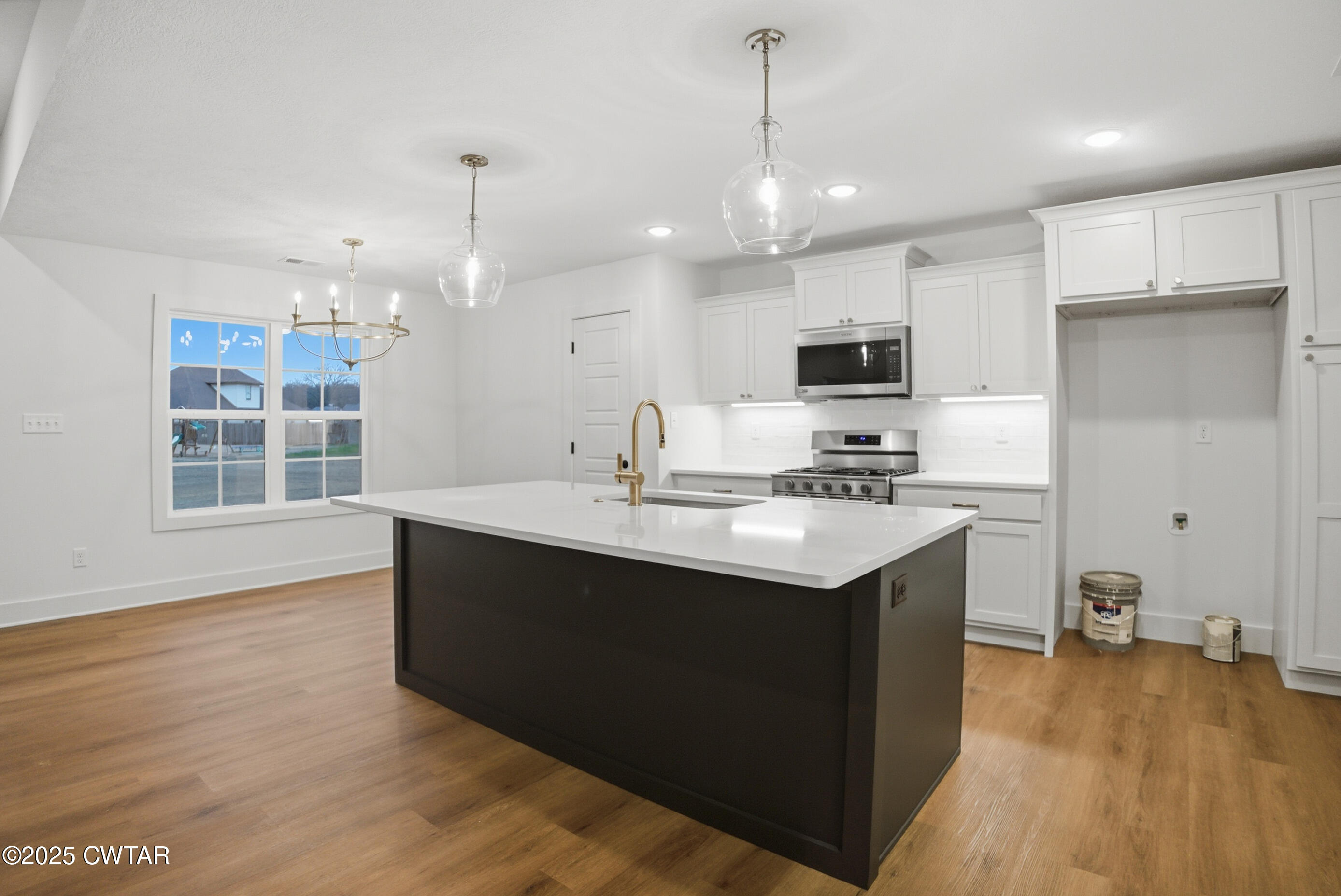 164 Daybreak Loop Medina, TN 38355 - Photo 16 of 40 a kitchen with kitchen island a sink stainless steel appliances and cabinets