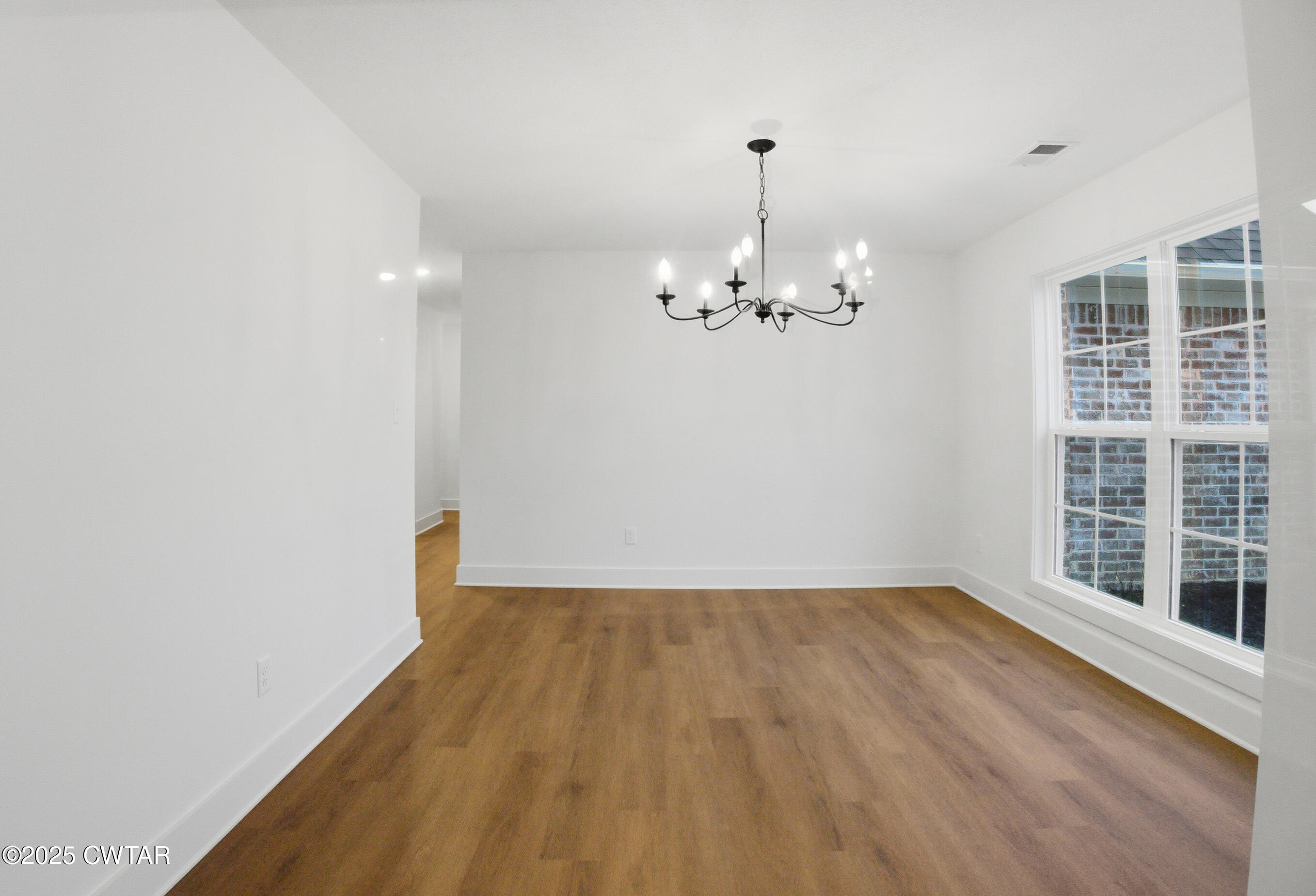 164 Daybreak Loop Medina, TN 38355 - Photo 20 of 40 a view of empty room with wooden floor and fan