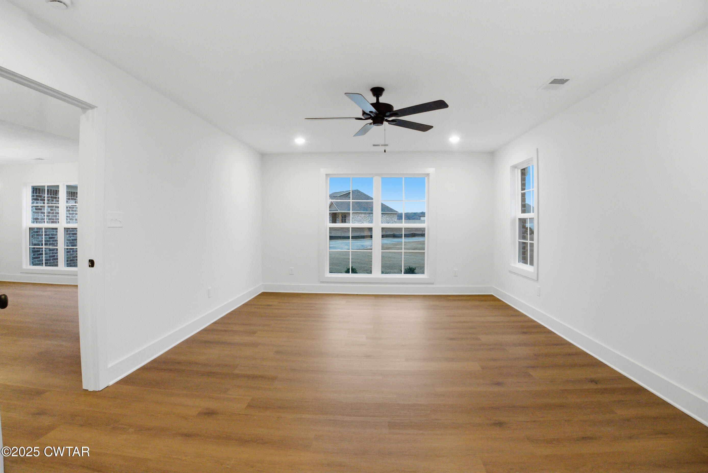 164 Daybreak Loop Medina, TN 38355 - Photo 22 of 40 a view of empty room with wooden floor and fan
