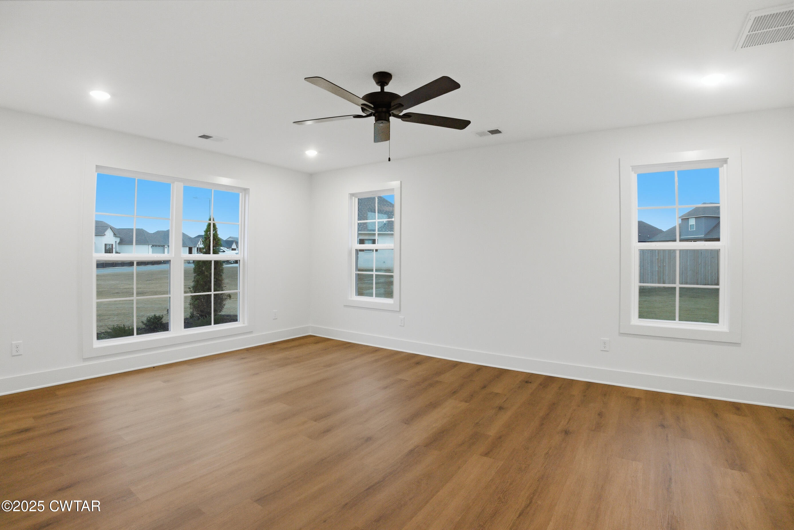 164 Daybreak Loop Medina, TN 38355 - Photo 23 of 40 a view of an empty room with a window and wooden floor