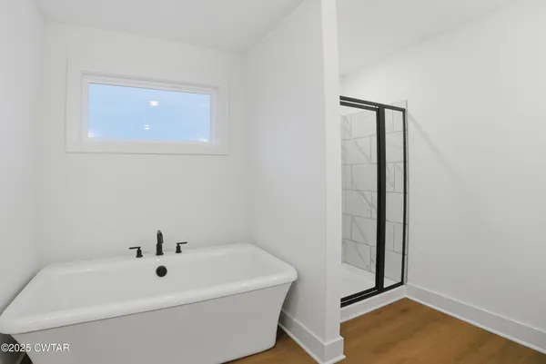 a bathroom with a toilet and a tub