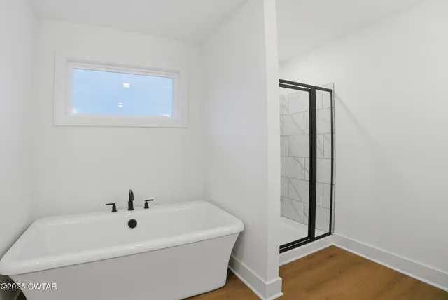 a bathroom with a toilet and a tub