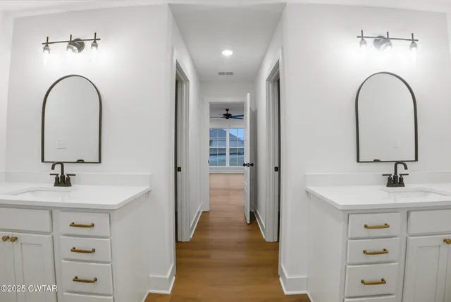 an empty room with a ceiling fan and window