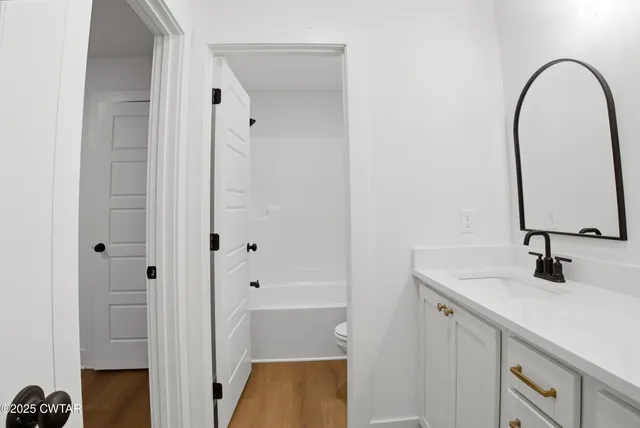 a bathroom with a double vanity sink and a mirror