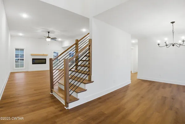 a view of entryway and hall with wooden floor