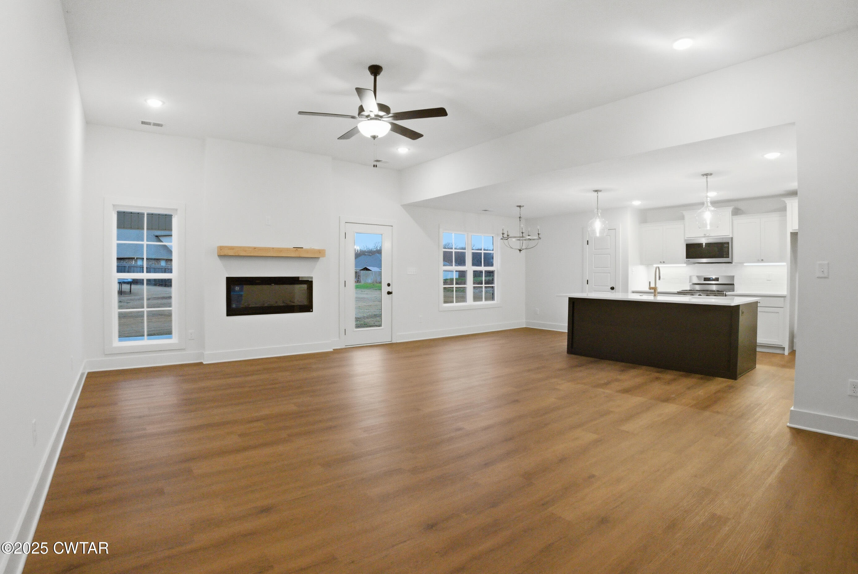 164 Daybreak Loop Medina, TN 38355 - Photo 5 of 40 a view of an empty room with window and wooden floor