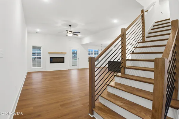 a view of a livingroom with wooden floor and white walls