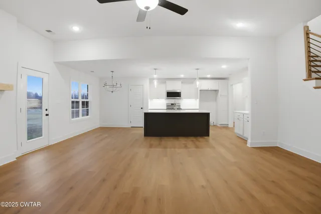 a kitchen with stainless steel appliances granite countertop a sink a stove top oven a counter space and cabinets