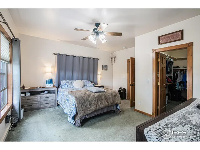 a living room with a bed furniture and a large window