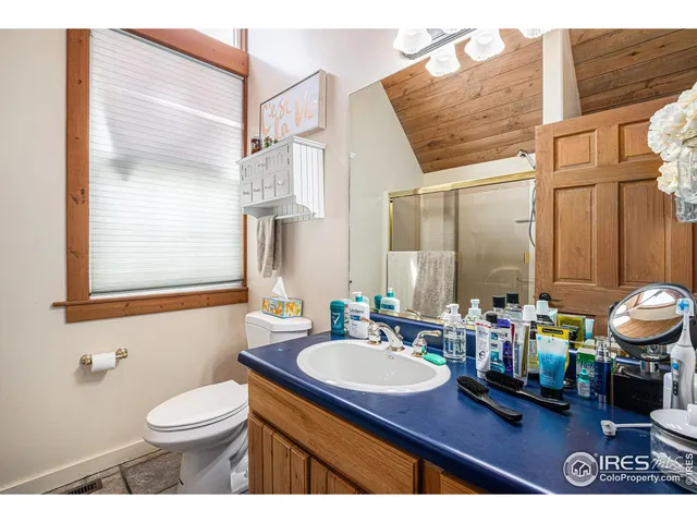 a bathroom with a sink mirror and a toilet