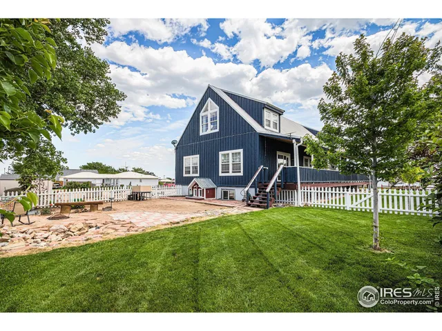 a house view with a sitting space and garden