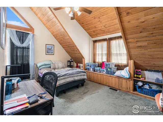 a bedroom with furniture and a wooden floor