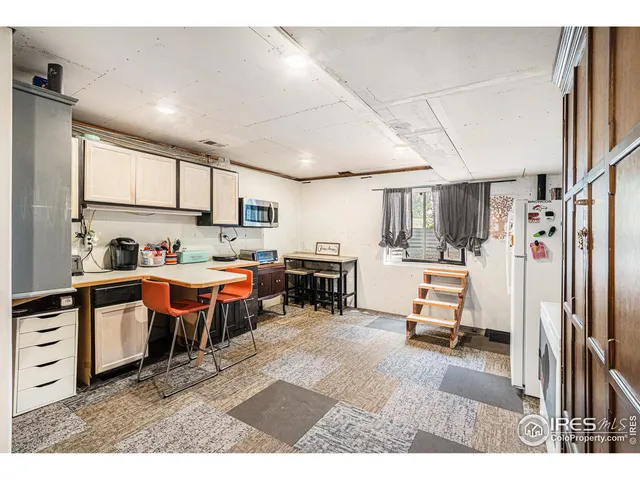 a kitchen with stainless steel appliances kitchen island granite countertop a refrigerator and a sink