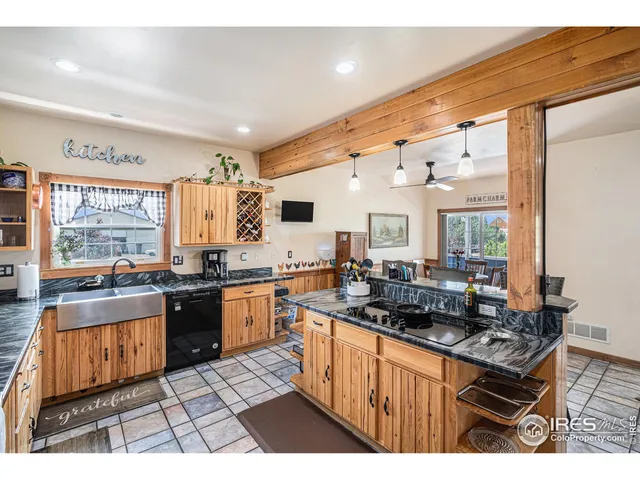 a large kitchen with lots of counter top space and stainless steel appliances