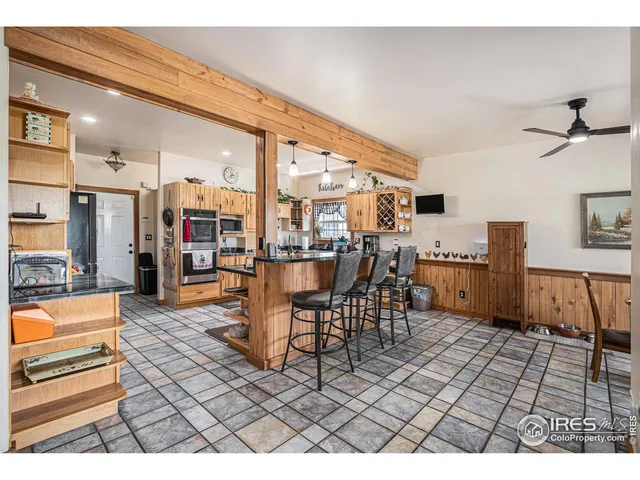 a living room with lots of furniture and kitchen view