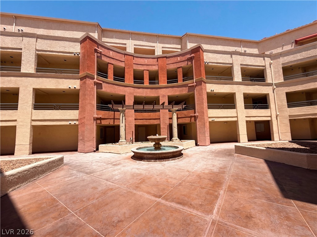 230 East Flamingo Road, Unit 320 Las Vegas, NV 89169 - Photo 18 of 19 An inviting courtyard welcomes residents to this multi-story building, centered around a charming water fountain feature.