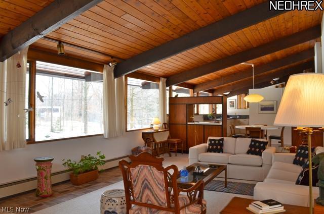 First floor Family room opening to kitchen and large screened porch.