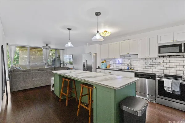 a kitchen with furniture a counter space appliances and cabinets