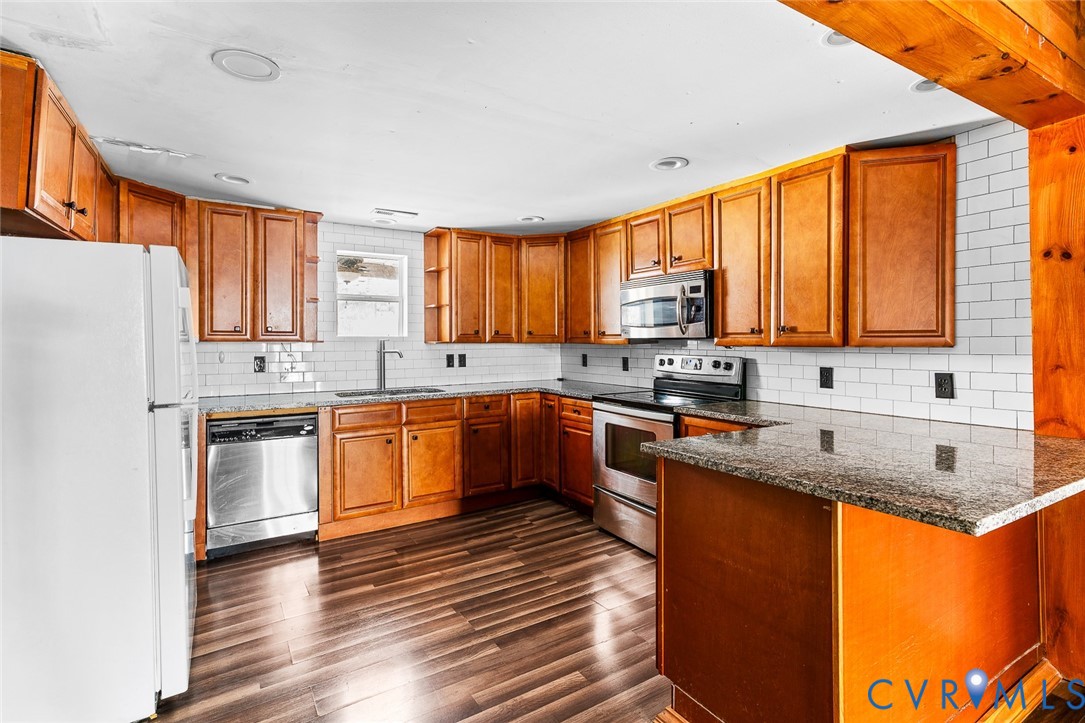 607 South Laurel Street Richmond, VA 23220 - Photo 5 of 14 a kitchen with stainless steel appliances granite countertop a sink stove and refrigerator