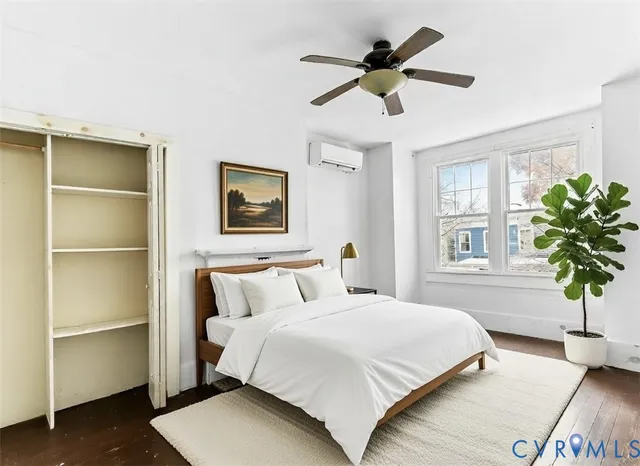 a bedroom with a bed and a potted plant