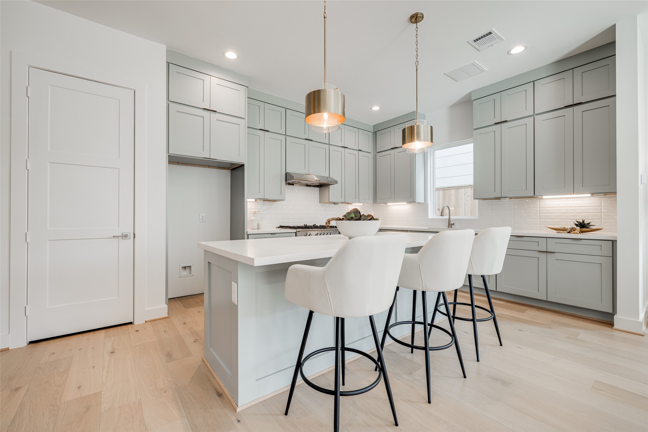 2015 Hopkins Street Houston, TX 77006 - Photo 22 of 50 a open kitchen with stainless steel appliances granite countertop a sink a stove a refrigerator and island with wooden floor