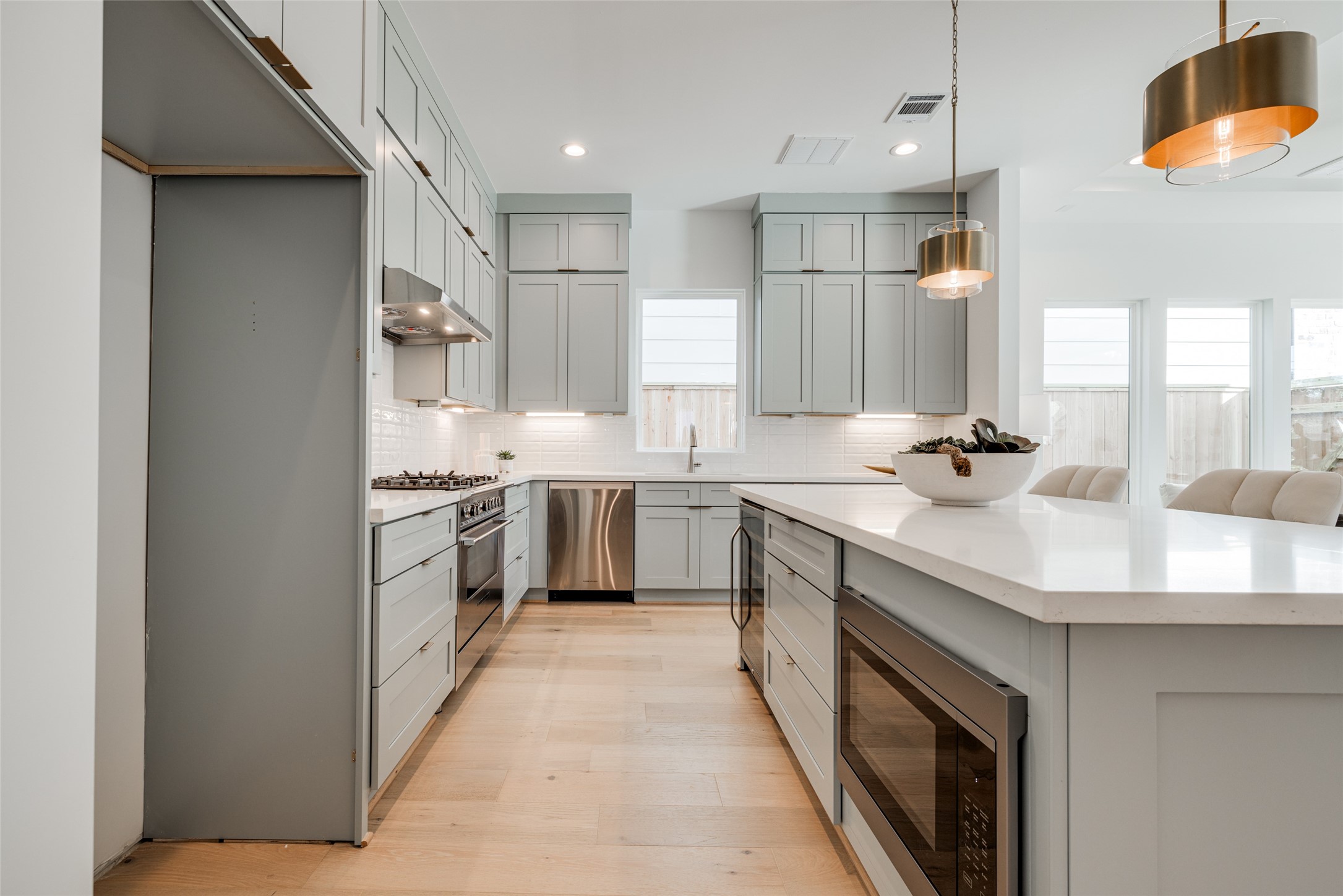 2015 Hopkins Street Houston, TX 77006 - Photo 23 of 50 a kitchen with white cabinets and sink