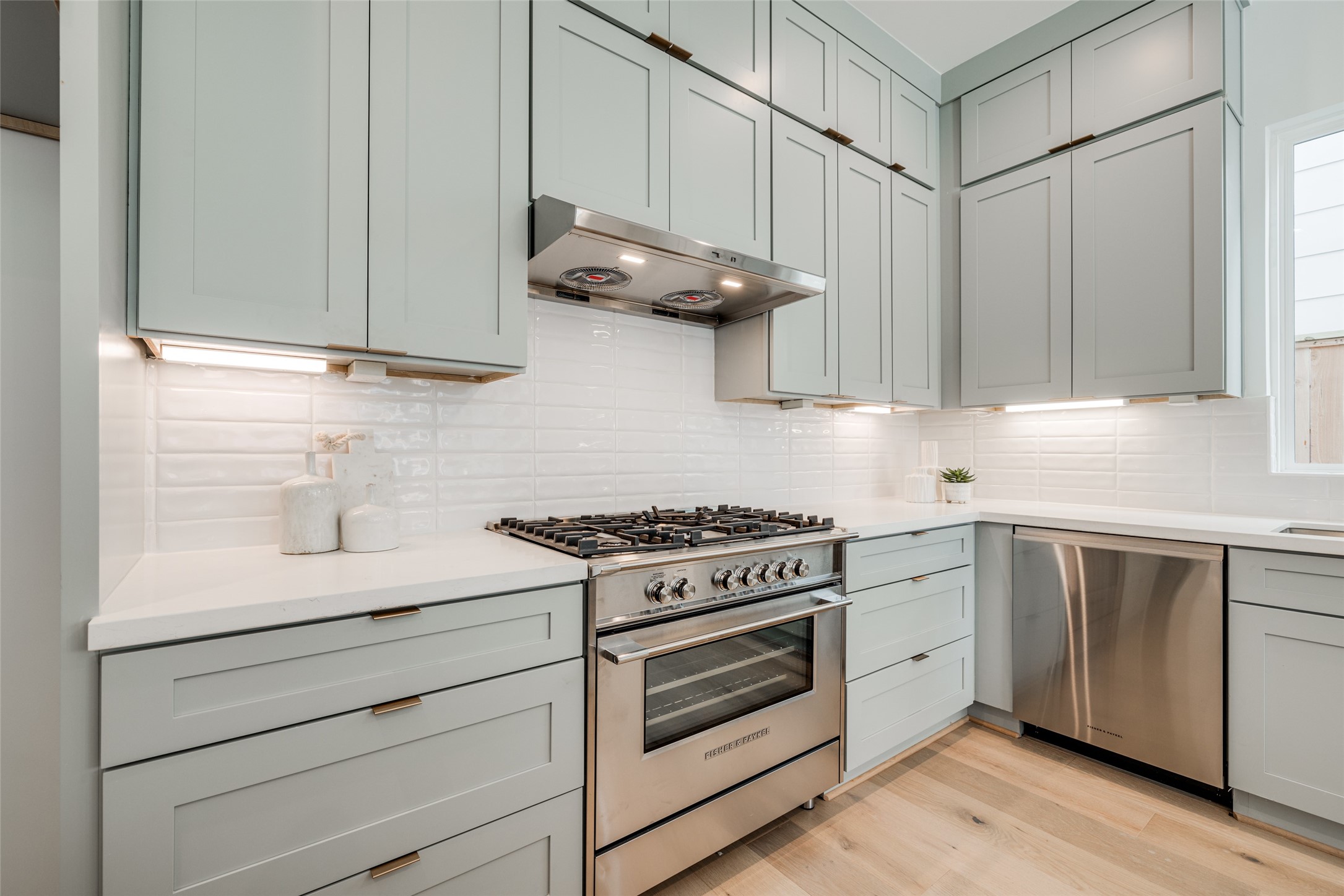 2015 Hopkins Street Houston, TX 77006 - Photo 25 of 50 a kitchen with stainless steel appliances granite countertop white cabinets and a stove top oven