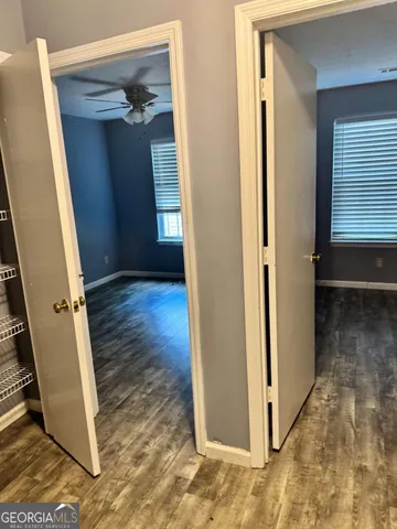 a view of a hallway with wooden floor and entryway
