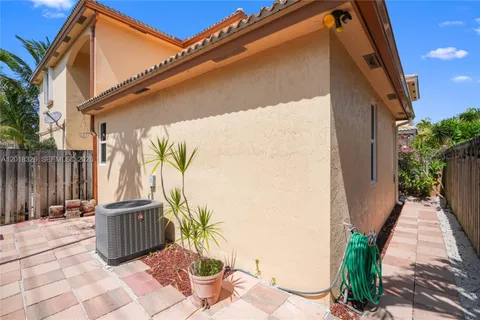 a view of a building with a yard and palm trees