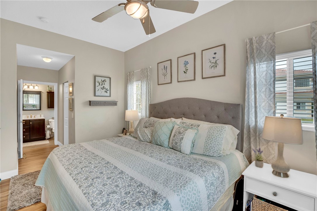 532 7th Square Southwest, Unit 101 Vero Beach, FL 32962 - Photo 16 of 33 a bedroom with a large bed and a chandelier
