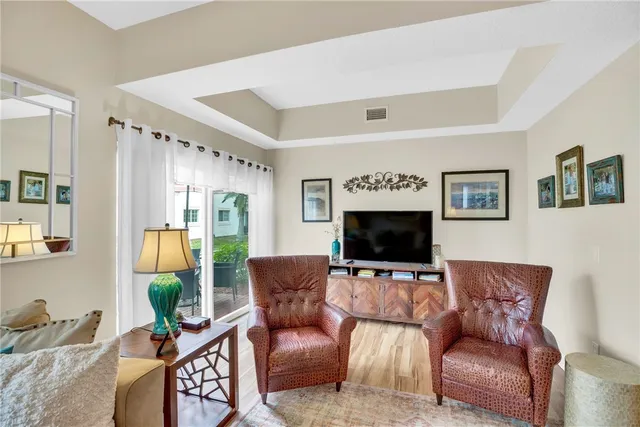 a kitchen with a refrigerator a stove a sink dishwasher and white cabinets with wooden floor