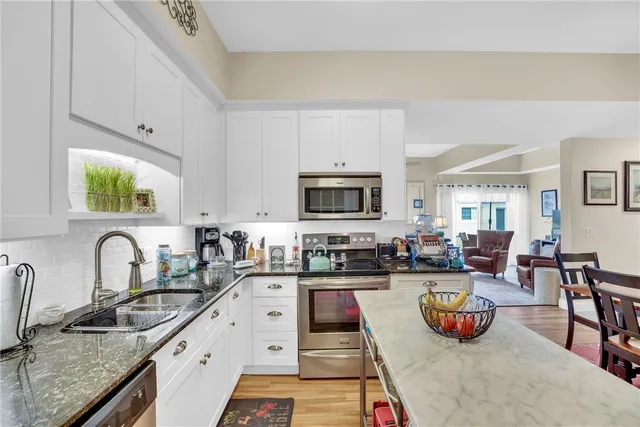 a dining room with lots of furniture and a chandelier