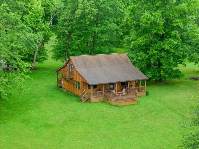 a aerial view of a house with a yard table and chairs