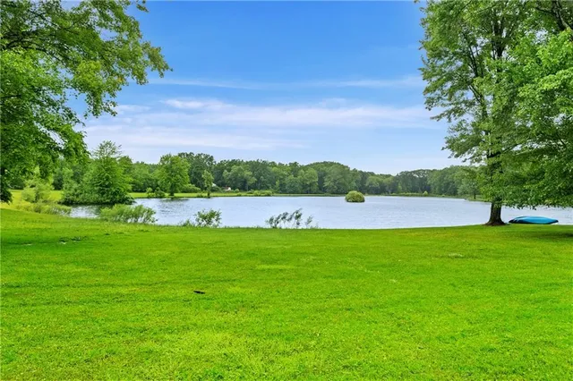 a view of outdoor space with swimming pool and green space