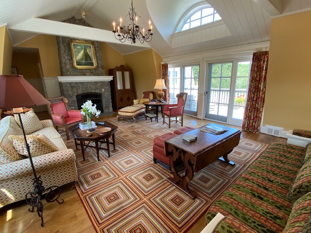 3 Katama Bay View Road Edgartown, MA 02539 - Photo 32 of 50 a living room with furniture a chandelier and a fireplace