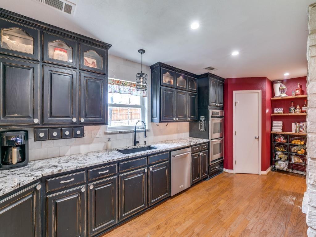 5440 South State Highway 78 Nevada, TX 75173 - Photo 10 of 28 a kitchen with stainless steel appliances granite countertop a sink and cabinets