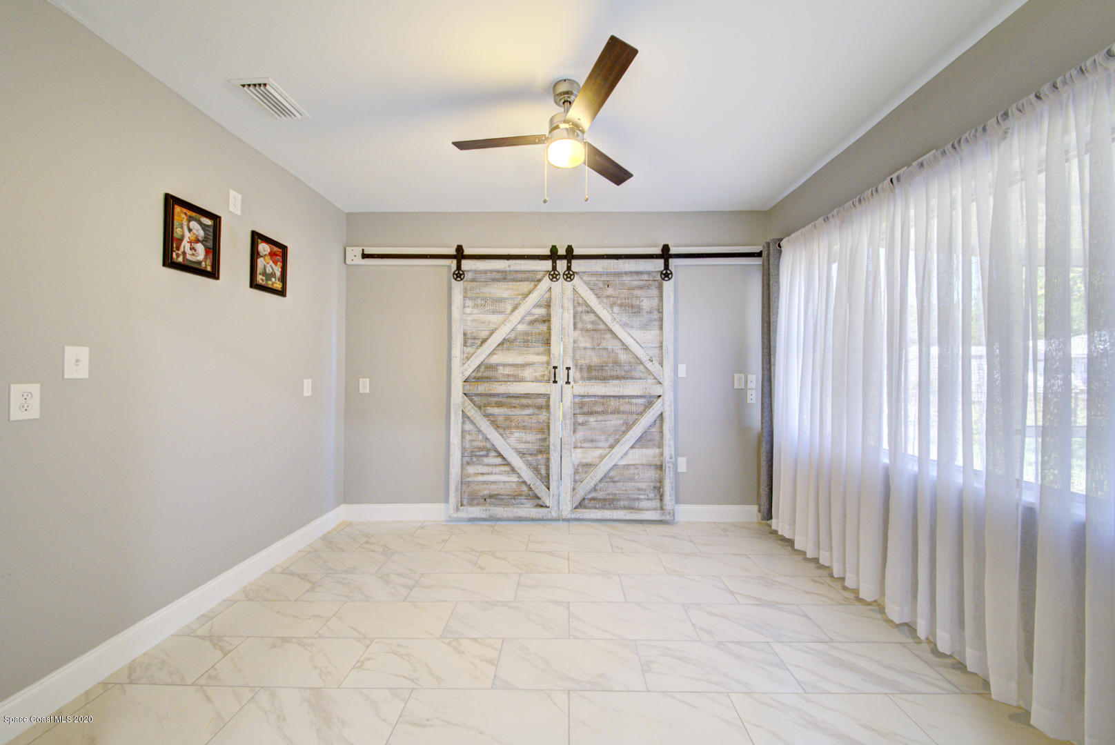 2138 Nottingham Road Melbourne, FL 32935 - Photo 14 of 40 Dining Room with Barn Doors