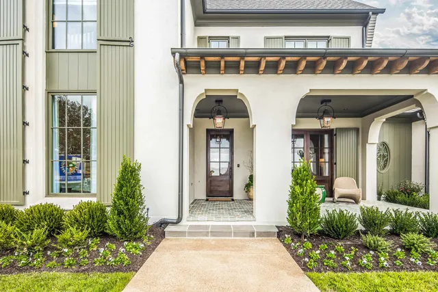 a front view of a house with garden