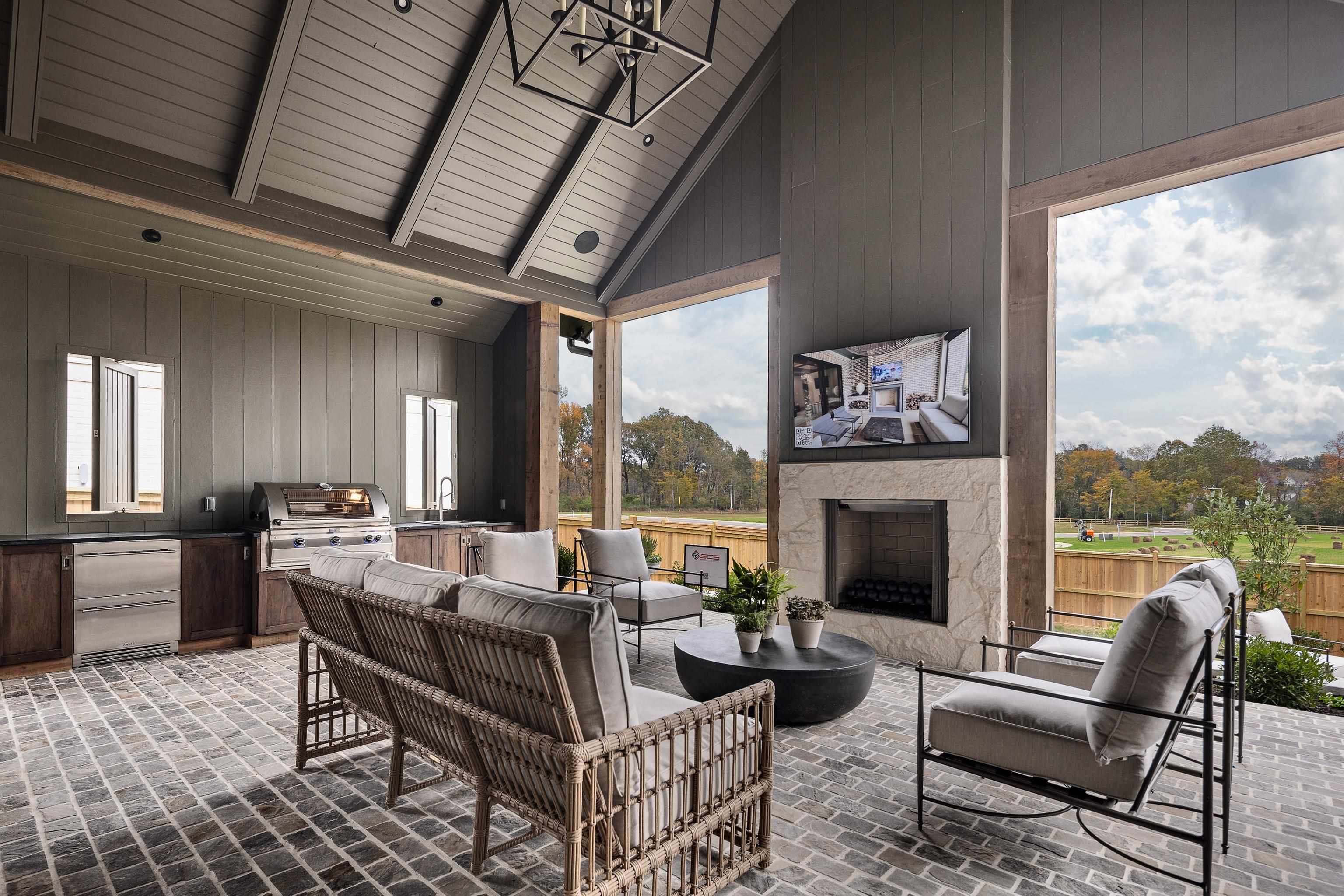 3310 Hidden Creek Loop Collierville, TN 38017 - Photo 34 of 40 a living room with furniture a fireplace and a floor to ceiling window